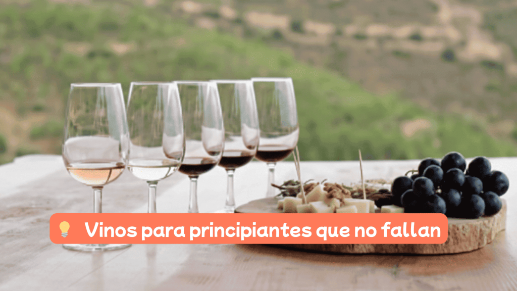 Vinos para principiantes que no fallan en una cata sobre mesa de madera con vistas a la montaña.